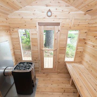 CT Georgian Cabin Sauna by the water — full exterior view with black metal roof and cedar walls