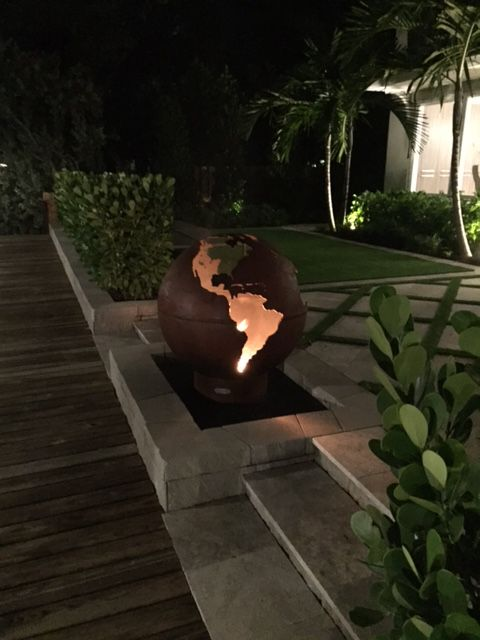 Third Rock Steel Fire Pit burning at lakeside sunset
