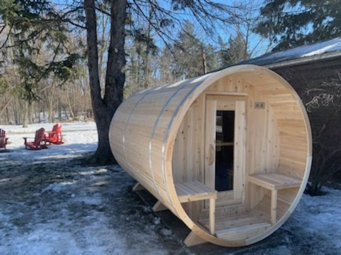 CT Serenity Barrel Sauna with wood stove in fall forest setting