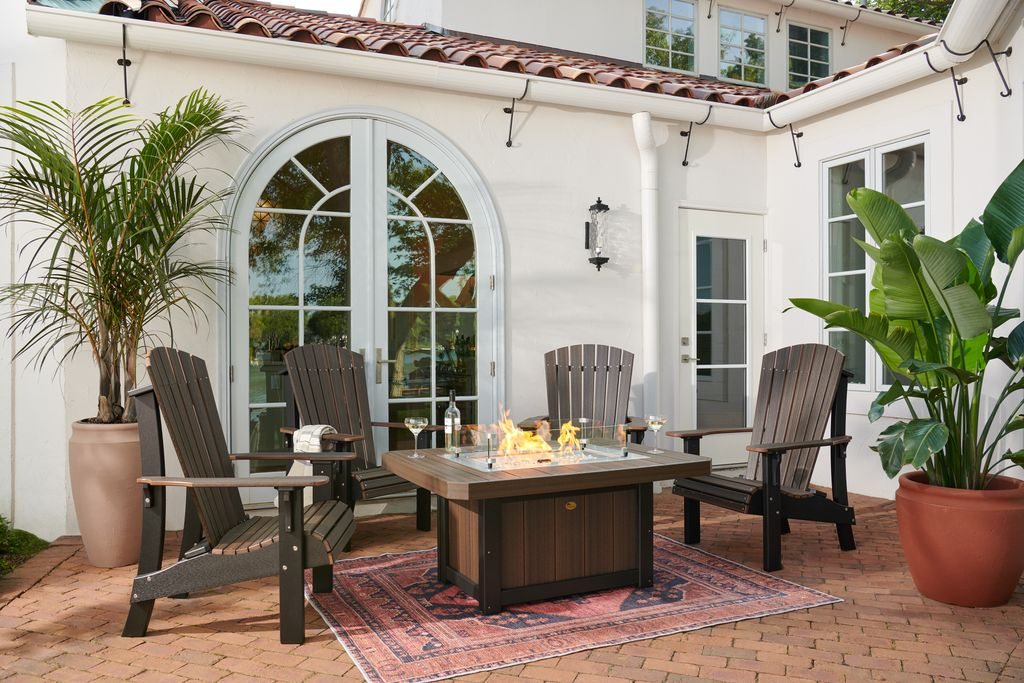 LFP51R Lumin Fire Pit 51 inch Rectangular on Mediterranean courtyard patio with Adirondack chairs