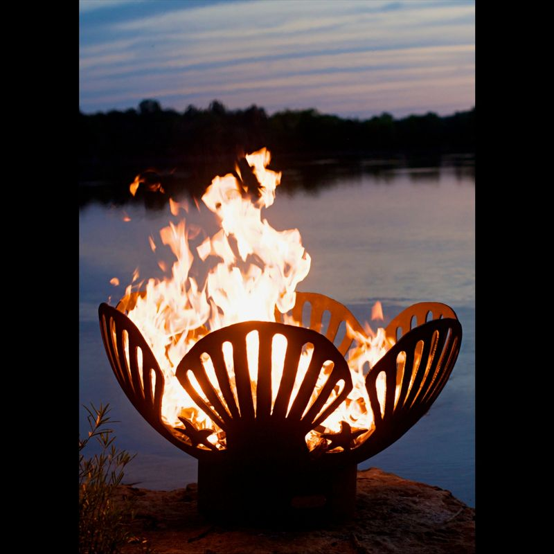 Barefoot Beach Fire Pit burning at dusk by the waterfront