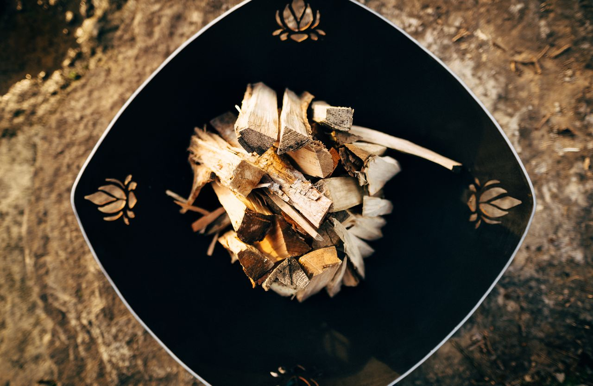 Firepit Art fire pit bowl with large flames outdoors